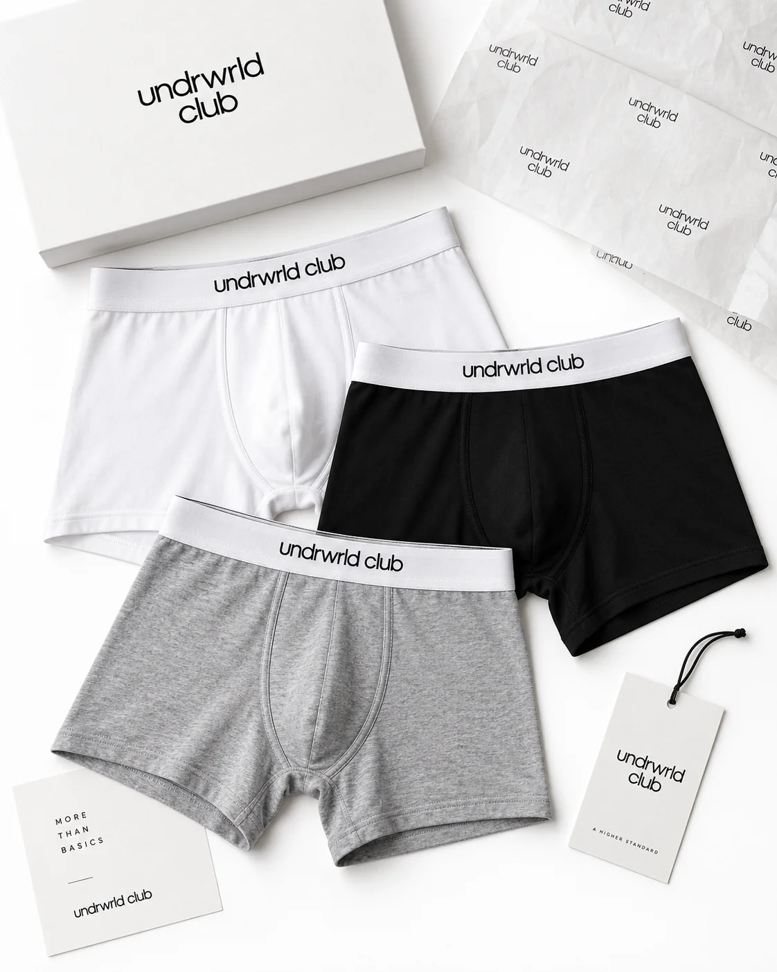 White, black, and gray undrwrld club boxer briefs arranged with branded packaging